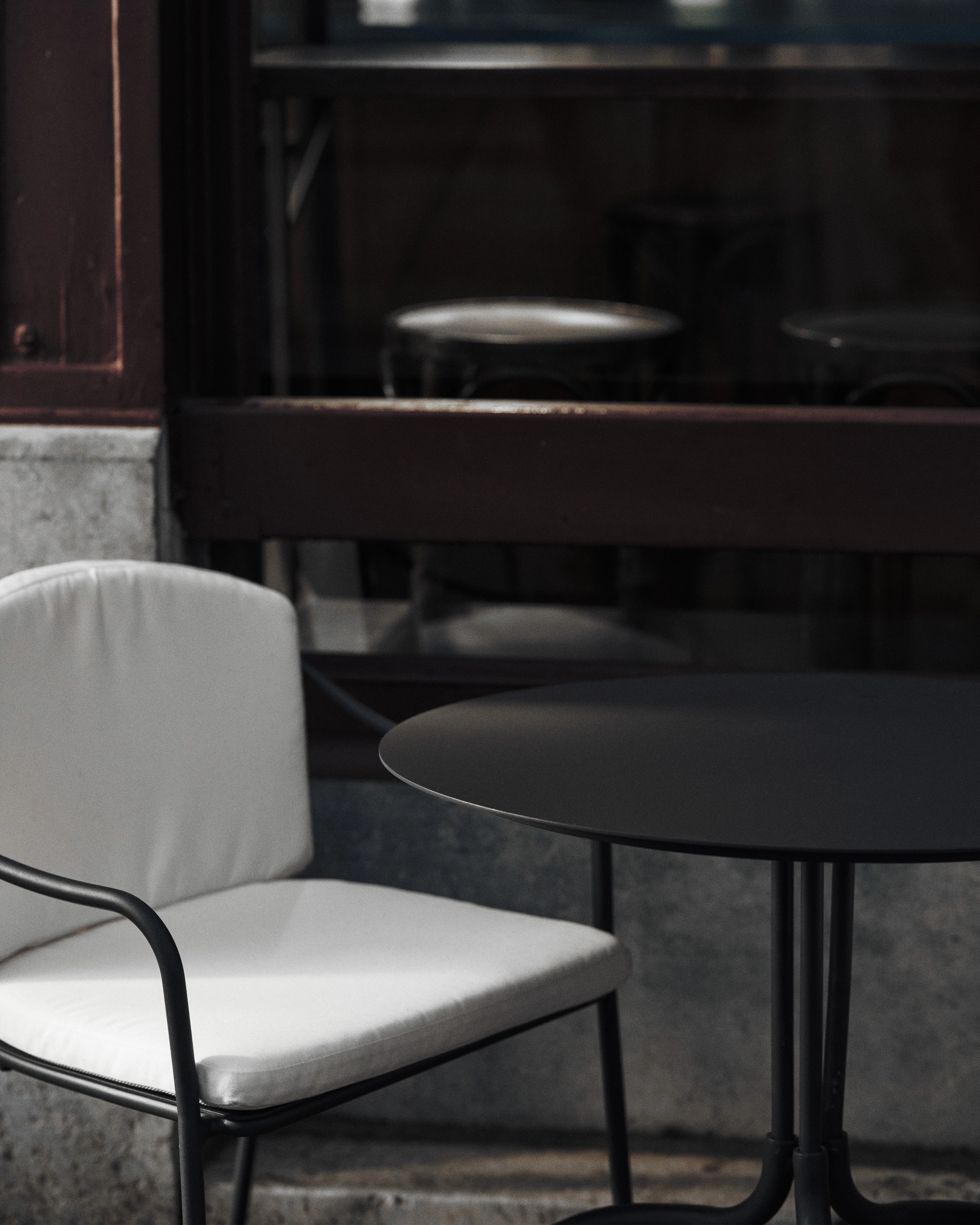 Black chair with armrests and white cushion included Patio - Image 2